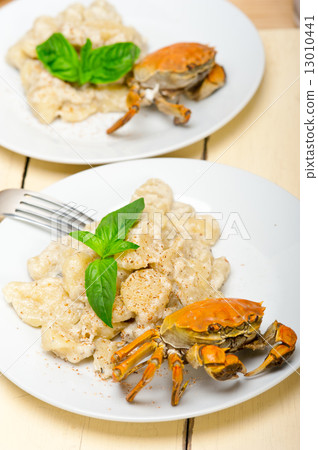 Italian gnocchi with seafood sauce with crab and basil Italian gnocchi with seafood sauce with crab and basil 13010441