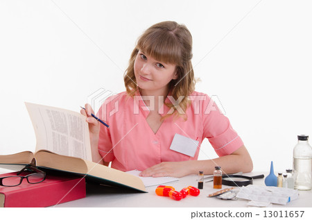 Pharmacist enjoy reading medication guide 13011657