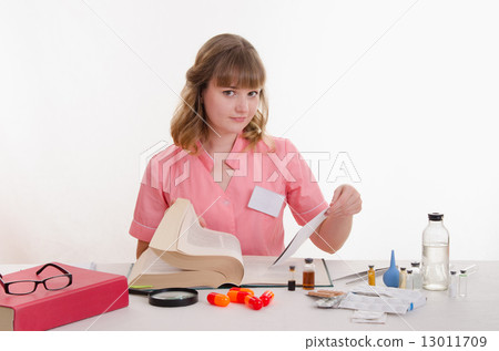 Pharmacist looking for right medicine in directory 13011709