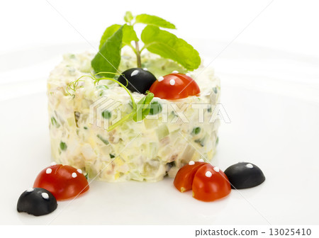 Olivier salad decorated with tomato in the shape of ladybugs 13025410
