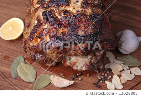 roasted meat on a cutting board. 13028805