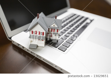 Miniature House on Laptop Computer 13029651