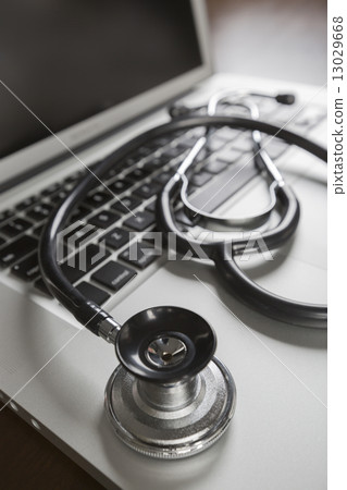 Medical Stethoscope Resting on Laptop Computer 13029668