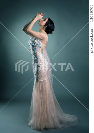 Pretty model posing in wedding dress with crystals 13029703