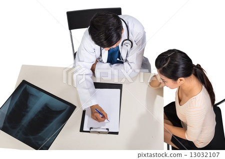 Doctor discussing with patient over medical condition Doctor discussing with patient over medical condition 13032107