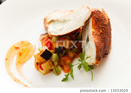 stuffed pork tenderloin roulade garnished with vegetables 13033029