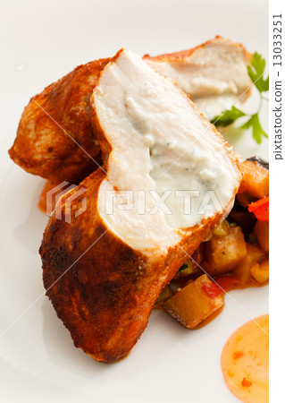 stuffed pork tenderloin roulade garnished with vegetables 13033251