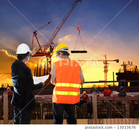 engineering man working in building construction site with worke 13033676