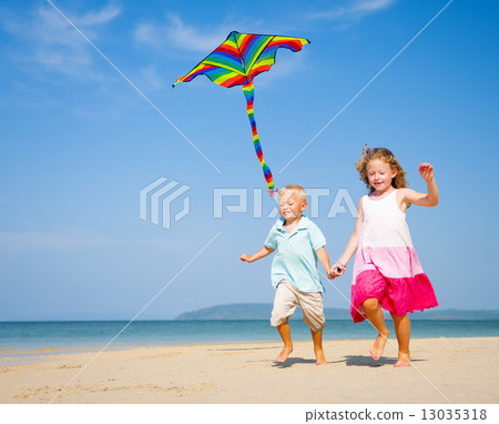 Children running on the beach Children running on the beach 13035318