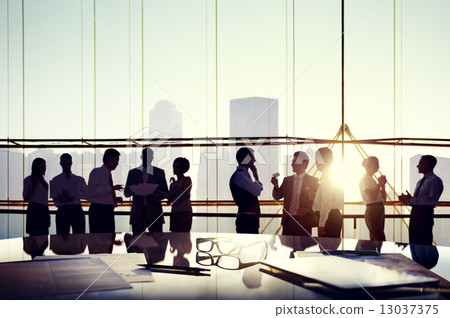 Group of business people discussing at sunset reflected onto tab Group of business people discussing at sunset reflected onto tab 13037375