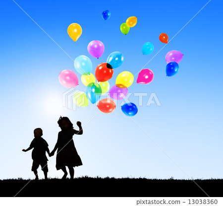 Two Children Outdoors Holding Balloons Two Children Outdoors Holding Balloons 13038360