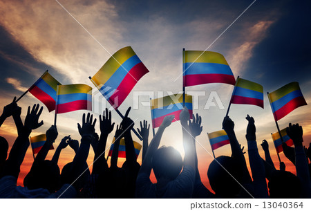 Group of People Waving Columbian Flags in Back Lit 13040364