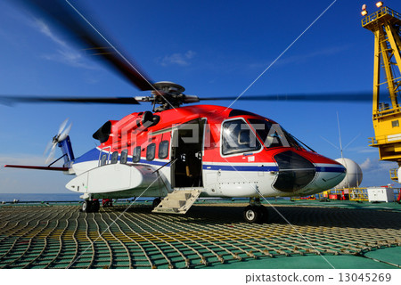 The helicopter park on oil rig to pick up worker The helicopter park on oil rig to pick up worker 13045269