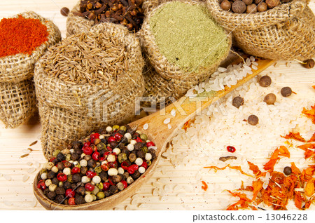 Powder spices on spoon and in pouches on a wooden table background Powder spices on spoon and in pouches on a wooden table background 13046228