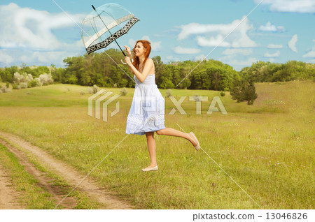 Levitating girl with umbrella flying above the ground. Levitating girl with umbrella flying above the ground. 13046826