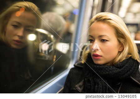 Woman looking out metro's window. Woman looking out metro's window. 13049105
