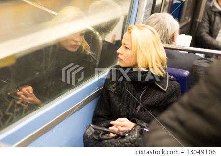 Woman looking out metro's window. 13049106