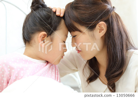 Mother nursing a sick child Mother nursing a sick child 13050666