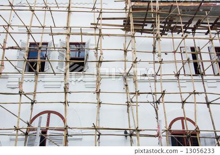 Wooden scaffolding around new building in Thailand 13056233