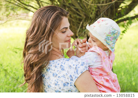 Baby girl with her mother giving a flower Baby girl with her mother giving a flower 13058815