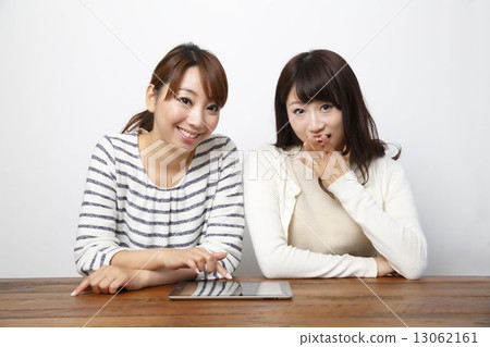 Two girls using tablet pc 13062161