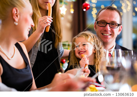 Family eating Christmas dinner at home Family eating Christmas dinner at home 13063610