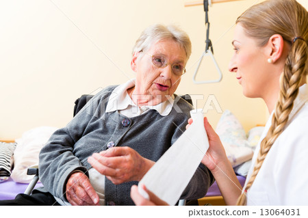 Nurse taking care of senior woman in retirement home Nurse taking care of senior woman in retirement home 13064031