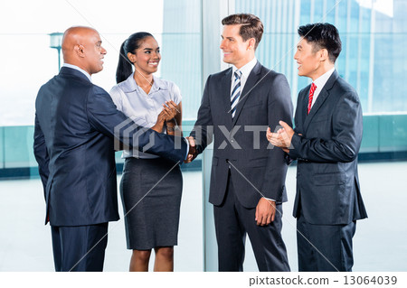 Business team having agreement and handshake Business team having agreement and handshake 13064039