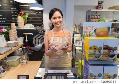 Smiling waitress at the counter 13069041
