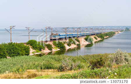 Passenger electric train on a dam Passenger electric train on a dam 13073170