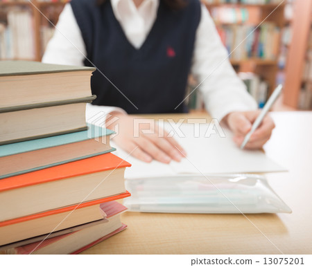 Studying in the library 13075201