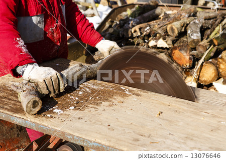 Man working with circular saw blade 13076646