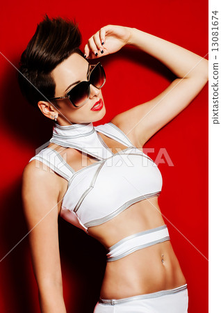 Beautiful model girl in swimsuit with sunglasses in the studio 13081674