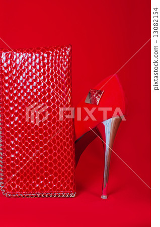Red high heels and purse on a red background 13082154