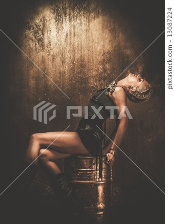 Attractive steampunk girl sitting on barrel 13087224