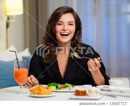 Beautiful woman having breakfast in a hotel room Beautiful woman having breakfast in a hotel room 13087717