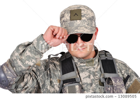 soldier adjusts his cap 13089505