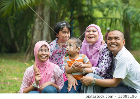 malay muslim family having fun playing in the park malay muslim family having fun playing in the park 13093190