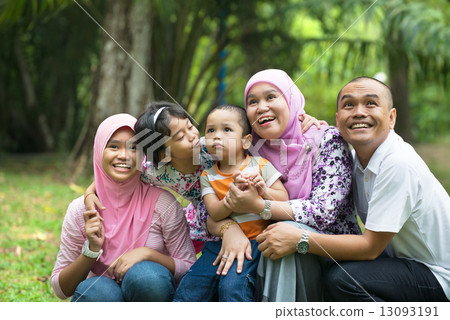 malay muslim family having fun playing in the park malay muslim family having fun playing in the park 13093191