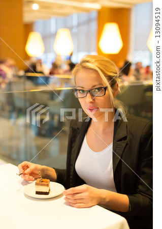 Women eating dessert in fancy restaurant. 13094519