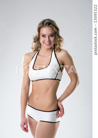 Pretty athletic girl smiling at camera 13095322
