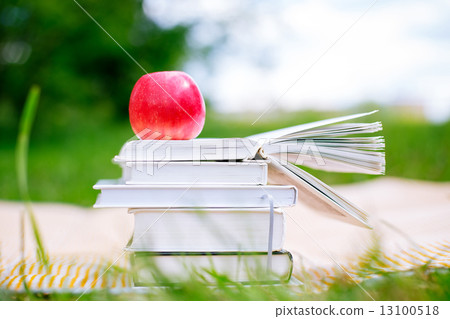 Open book with red apple 13100518