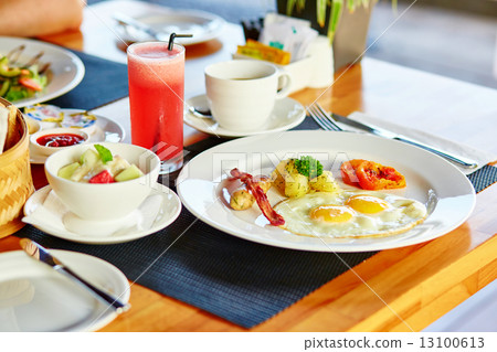 Fried eggs, fruit salad and juice for breakfast Fried eggs, fruit salad and juice for breakfast 13100613