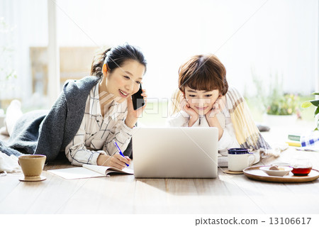 Two ladies watching laptop computers 13106617