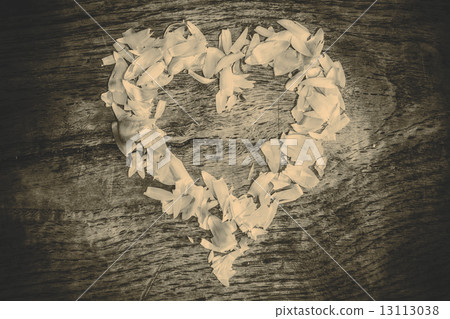 A heart from petals lying on a wooden table 13113038