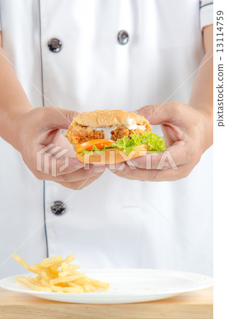 chef holding fried chicken burger chef holding fried chicken burger 13114759