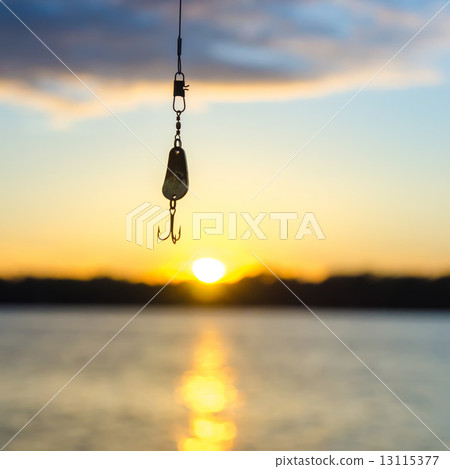 fishing on a lake before sunset fishing on a lake before sunset 13115377