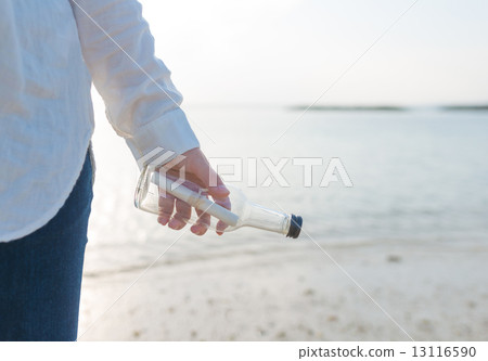 A woman with a message bottle 13116590