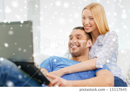 smiling happy couple with laptop at home smiling happy couple with laptop at home 13117645