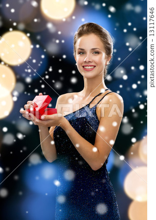 smiling woman holding red gift box 13117646